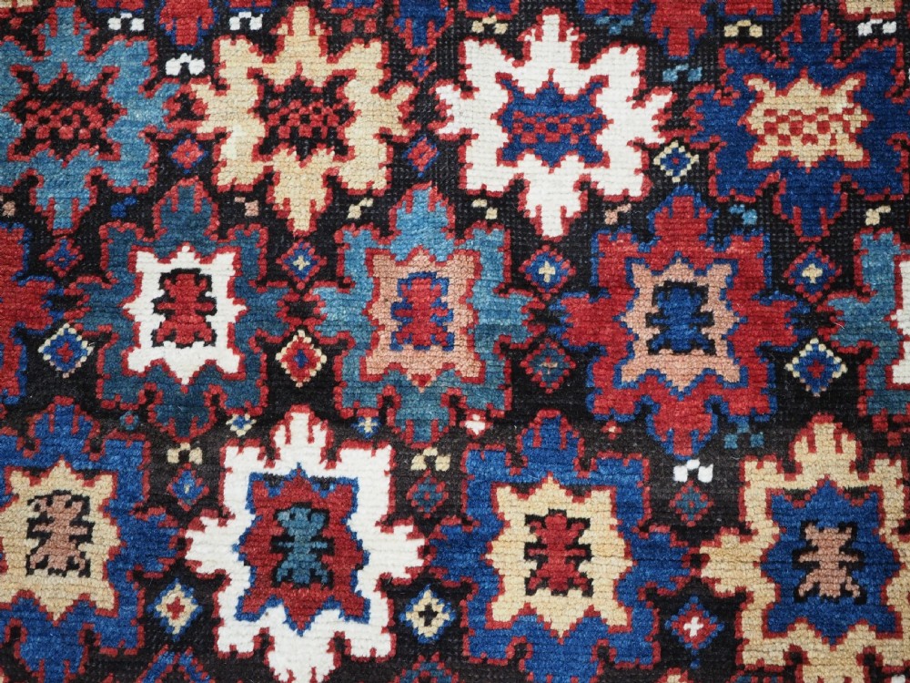 ANTIQUE CAUCASIAN DAGESTAN RUG WITH BLOSSOM DESIGN, CIRCA 1880. View X