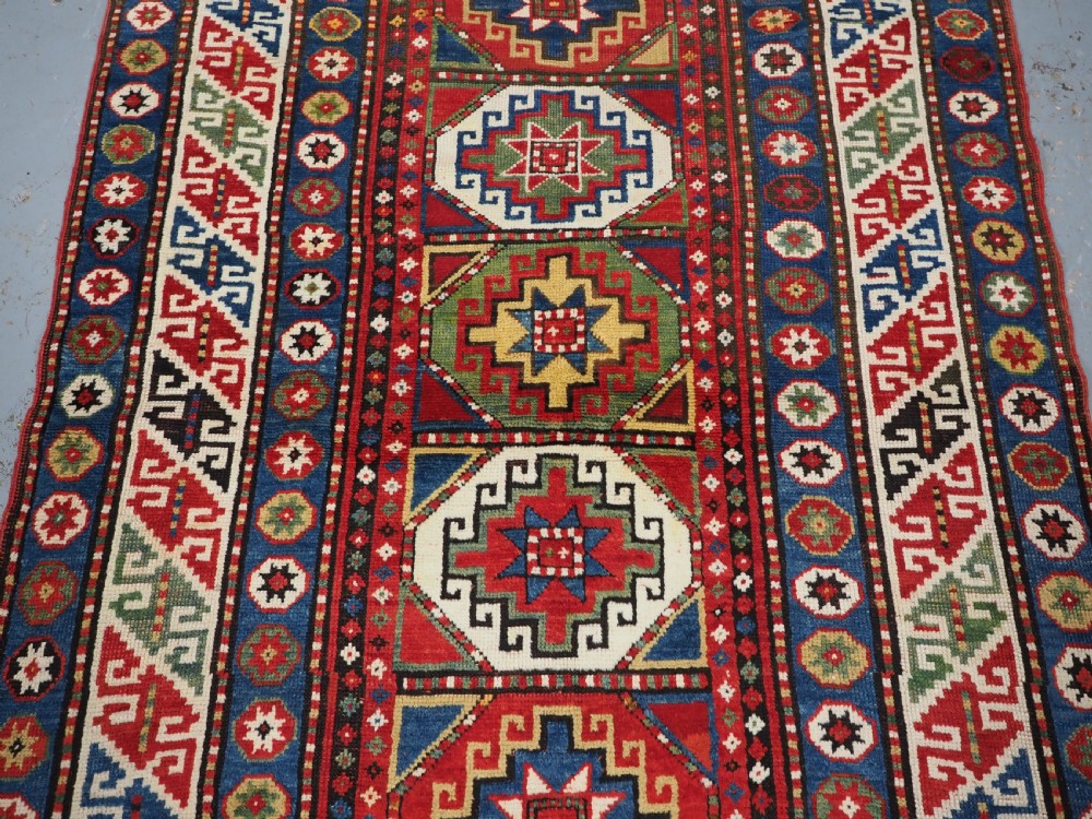 ANTIQUE CAUCASIAN KAZAK RUG WITH 'MEMLINC' GUL DESIGN, CIRCA 1890. View IV