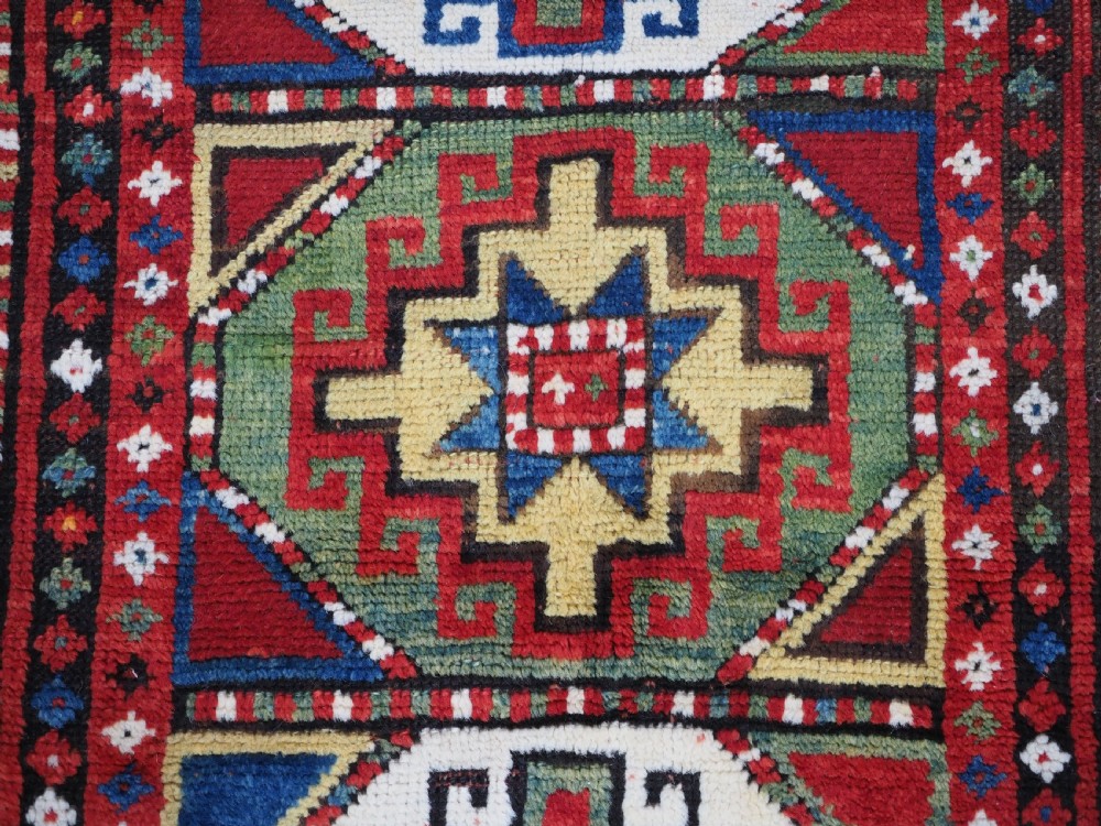 ANTIQUE CAUCASIAN KAZAK RUG WITH 'MEMLINC' GUL DESIGN, CIRCA 1890. View IX
