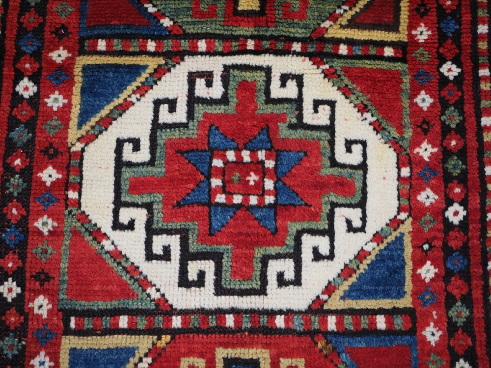 ANTIQUE CAUCASIAN KAZAK RUG WITH 'MEMLINC' GUL DESIGN, CIRCA 1890. View X