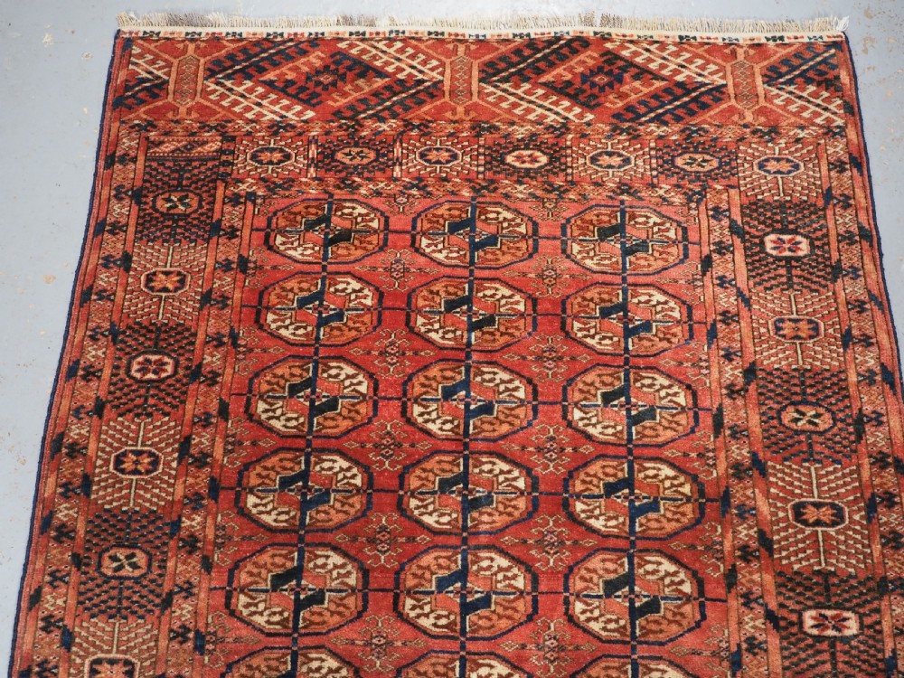 ANTIQUE TEKKE TURKMEN 'DIP KHALI' RUG, SOFT WARM RED COLOUR, CIRCA 1900. View III