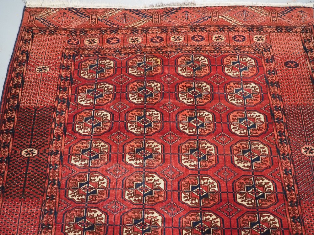 ANTIQUE TEKKE TURKMEN RUG WITH WARM RED COLOUR, CIRCA 1900. View III