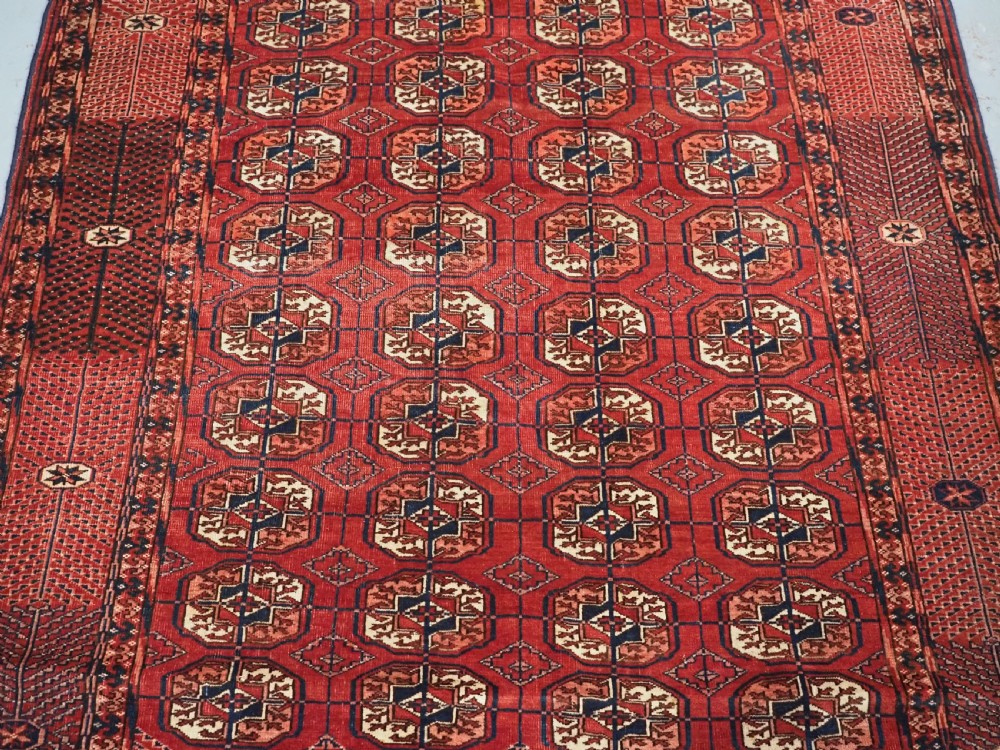 ANTIQUE TEKKE TURKMEN RUG WITH WARM RED COLOUR, CIRCA 1900. View IV