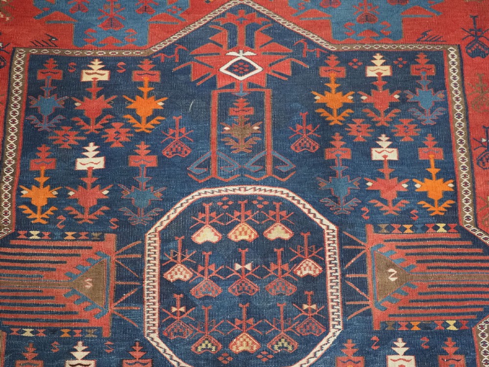 An antique flatweave Caucasian Avar kilim runner featuring geometric octagonal medallions down a navy centre field framed by terracotta and blue patterned borders. View VIII