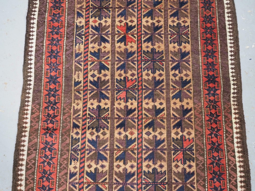 ANTIQUE BALUCH RUG WITH REPEAT LOTUS LEAF DESIGN, CIRCA 1900. View IV