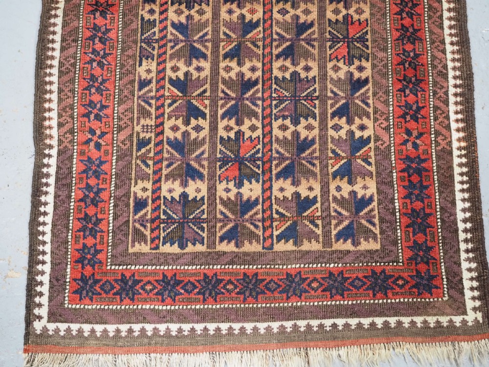 ANTIQUE BALUCH RUG WITH REPEAT LOTUS LEAF DESIGN, CIRCA 1900. View VI