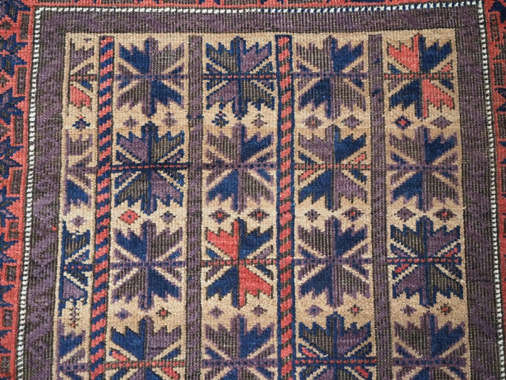 ANTIQUE BALUCH RUG WITH REPEAT LOTUS LEAF DESIGN, CIRCA 1900. View VIII