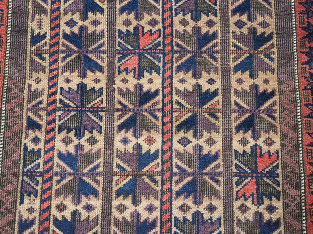 ANTIQUE BALUCH RUG WITH REPEAT LOTUS LEAF DESIGN, CIRCA 1900. View IX