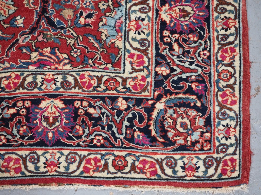 An antique hand-knotted Persian Tabriz wool rug featuring a dark navy central medallion surrounded by a red floral field and decorative navy borders. View XI