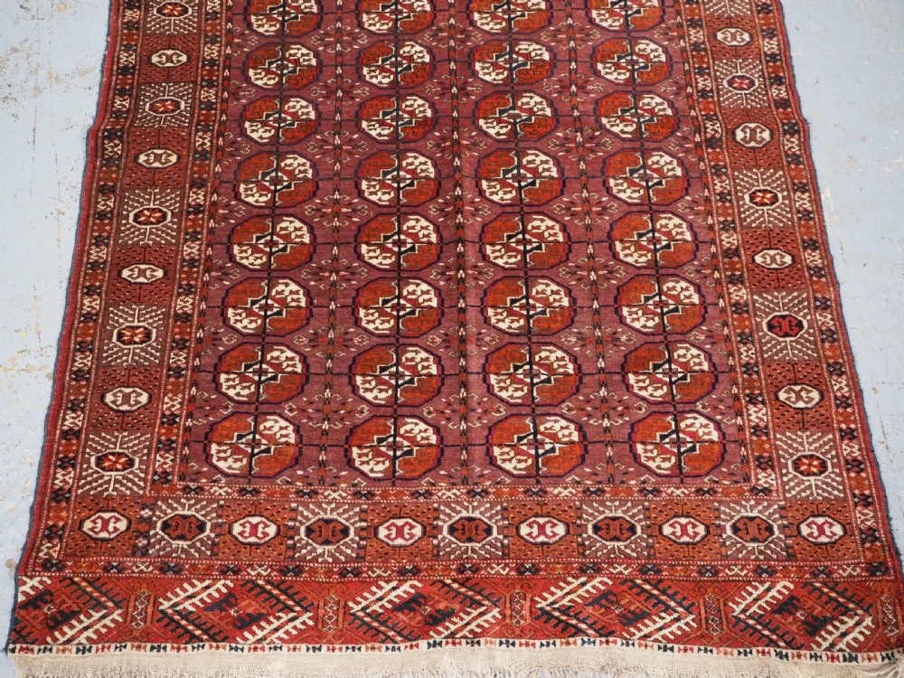 ANTIQUE TEKKE TURKMEN 'DIP KHALI' RUG WITH AUBERGINE FIELD COLOUR, CIRCA 1900. View V