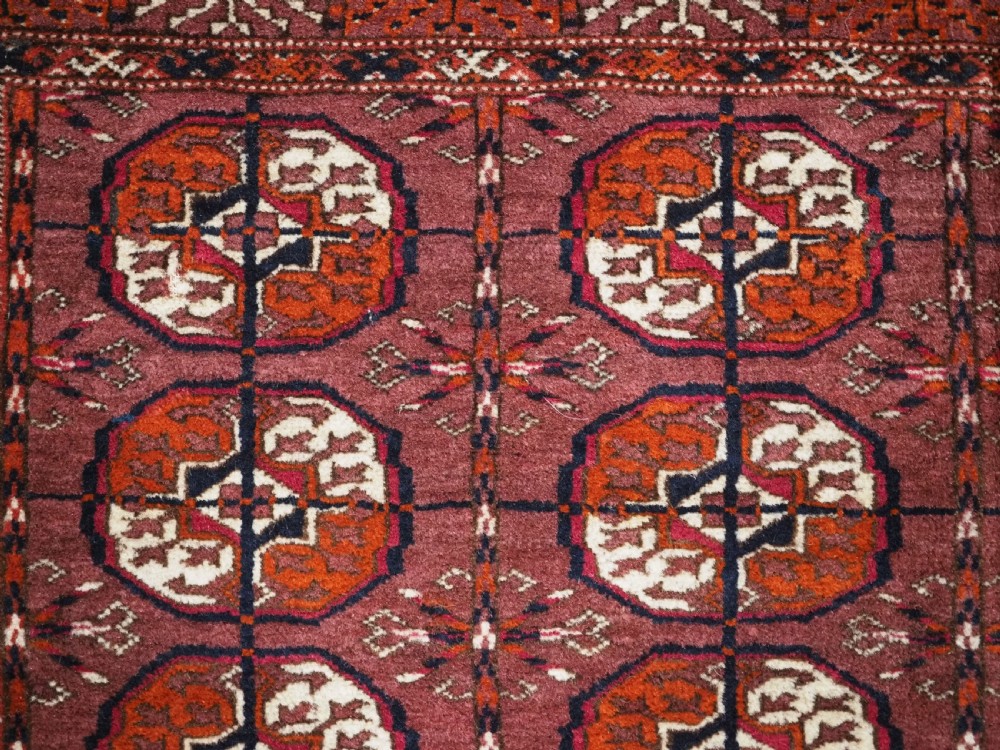 ANTIQUE TEKKE TURKMEN 'DIP KHALI' RUG WITH AUBERGINE FIELD COLOUR, CIRCA 1900. View VIII