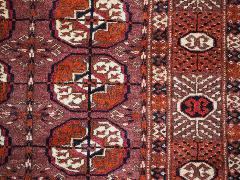 ANTIQUE TEKKE TURKMEN 'DIP KHALI' RUG WITH AUBERGINE FIELD COLOUR, CIRCA 1900. View X