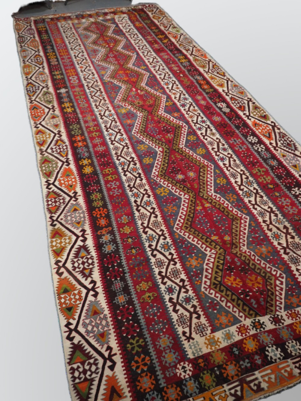 A large flatwoven antique Turkish Kayseri wool kilim rug featuring central red diamond medallions surrounded by geometric patterned borders. View II