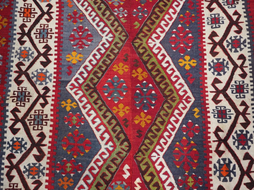 A large flatwoven antique Turkish Kayseri wool kilim rug featuring central red diamond medallions surrounded by geometric patterned borders. View XI