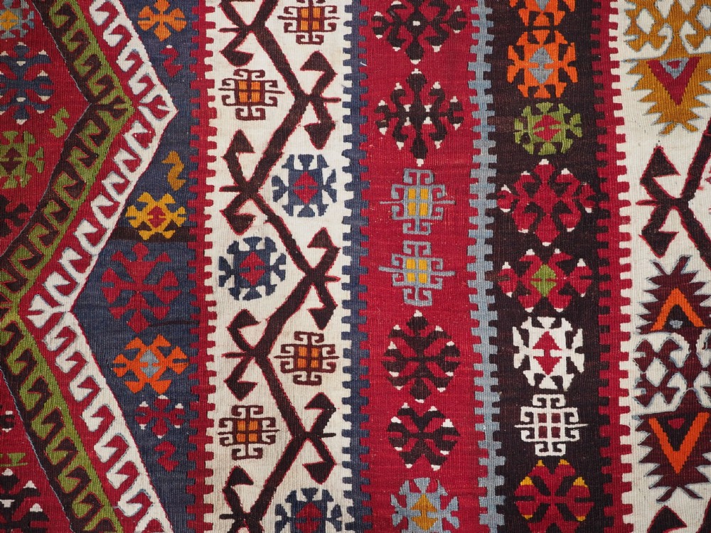 A large flatwoven antique Turkish Kayseri wool kilim rug featuring central red diamond medallions surrounded by geometric patterned borders. View XII