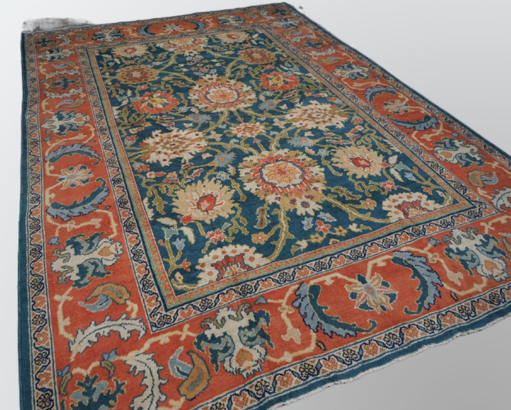 A hand-knotted Persian Mahal carpet with a central blue field decorated with floral palmettes and framed by a wide terracotta border. View II