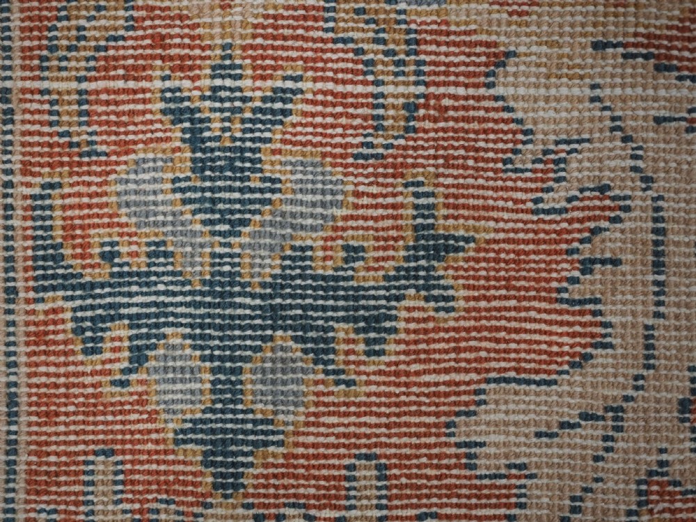 A hand-knotted Persian Mahal carpet with a central blue field decorated with floral palmettes and framed by a wide terracotta border. View XVII