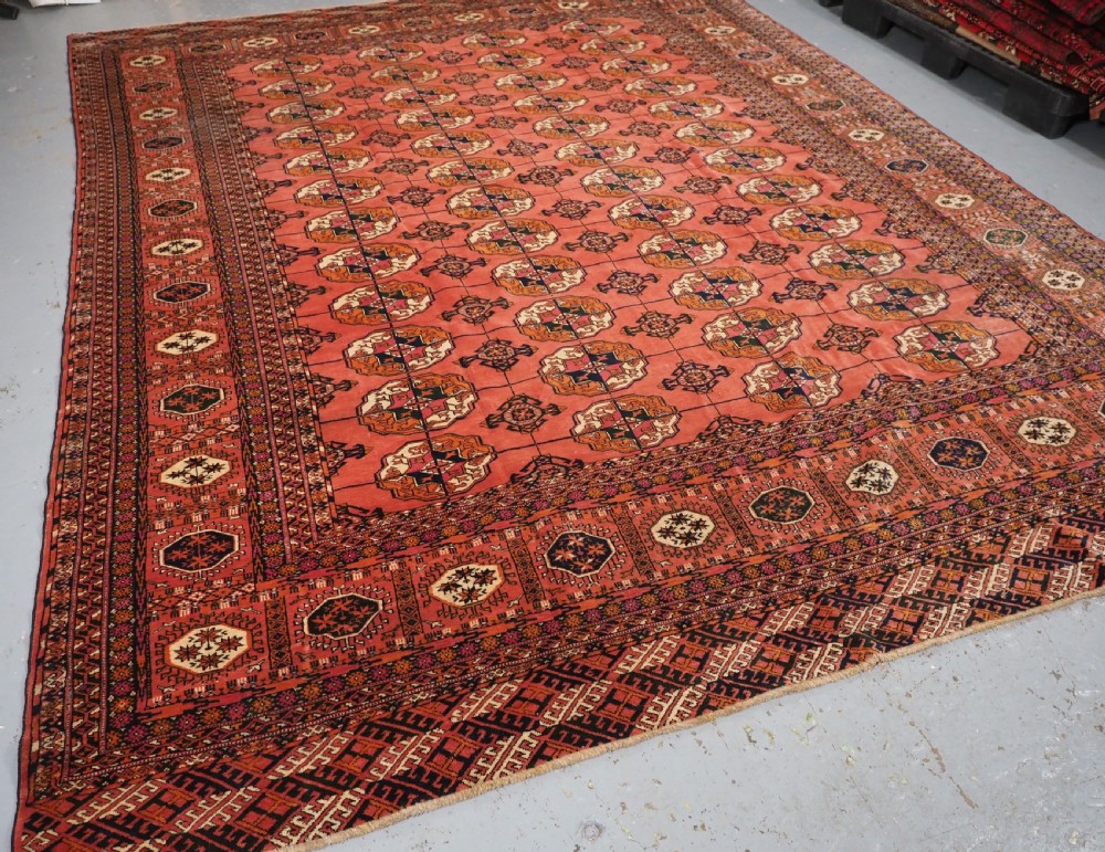 ANTIQUE TEKKE TURKMEN MAIN CARPET IN A SOFT WARM PINK / RED COLOUR, CIRCA 1900. View II
