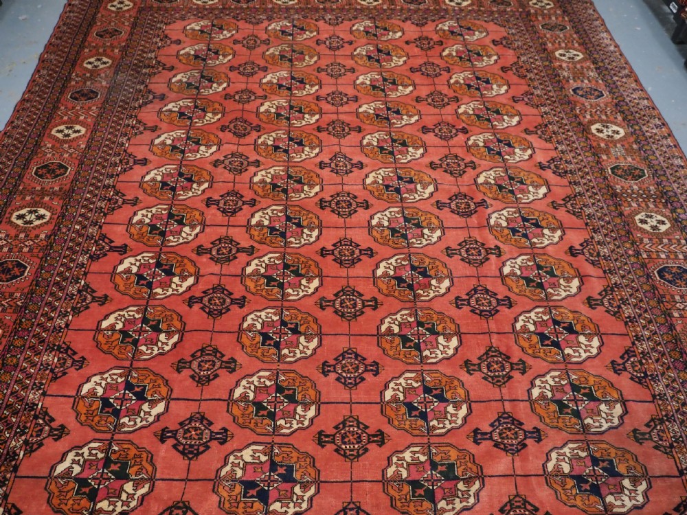 ANTIQUE TEKKE TURKMEN MAIN CARPET IN A SOFT WARM PINK / RED COLOUR, CIRCA 1900. View IV