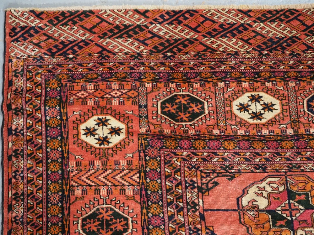 ANTIQUE TEKKE TURKMEN MAIN CARPET IN A SOFT WARM PINK / RED COLOUR, CIRCA 1900. View VI