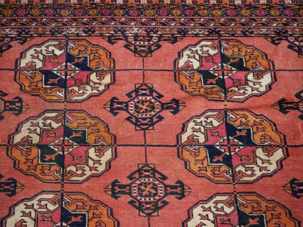 ANTIQUE TEKKE TURKMEN MAIN CARPET IN A SOFT WARM PINK / RED COLOUR, CIRCA 1900. View VIII
