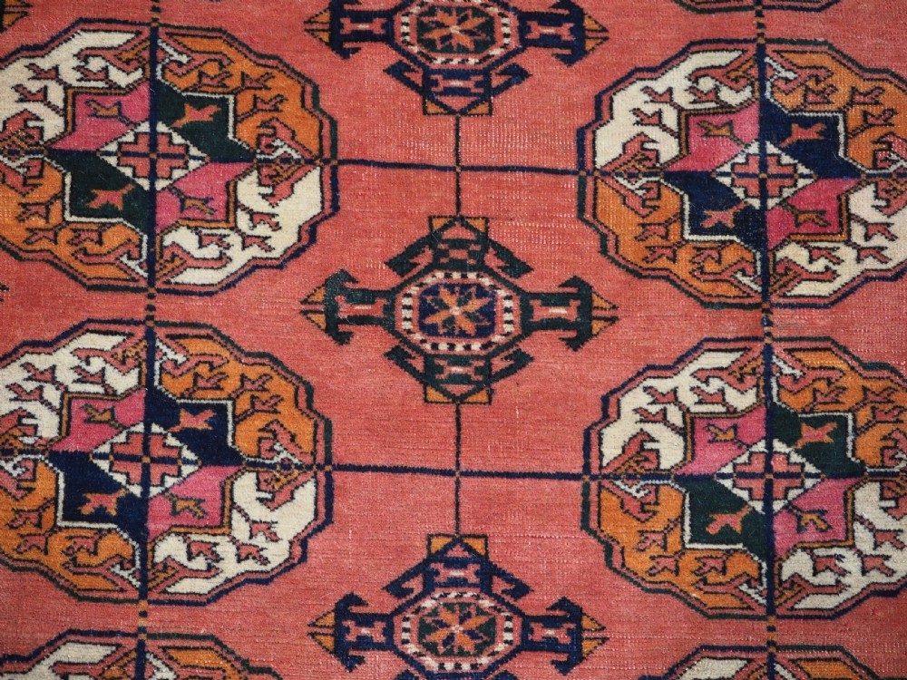 ANTIQUE TEKKE TURKMEN MAIN CARPET IN A SOFT WARM PINK / RED COLOUR, CIRCA 1900. View IX