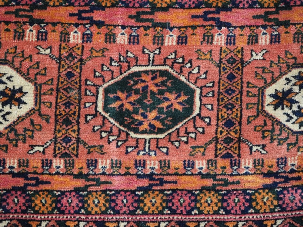 ANTIQUE TEKKE TURKMEN MAIN CARPET IN A SOFT WARM PINK / RED COLOUR, CIRCA 1900. View XI