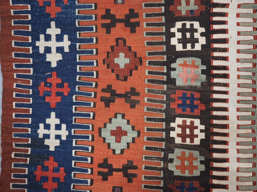 An antique handwoven Turkish Obruk kilim rug featuring a central mihrab niche motif surrounded by geometric borders in terracotta red, dark blue, green, and dark brown. View VII