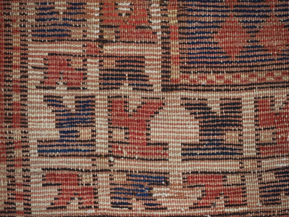 An antique Caucasian Bordjalou Kazak hand-knotted wool rug featuring three stepped geometric medallions on a vibrant red field within patterned borders. View XIII
