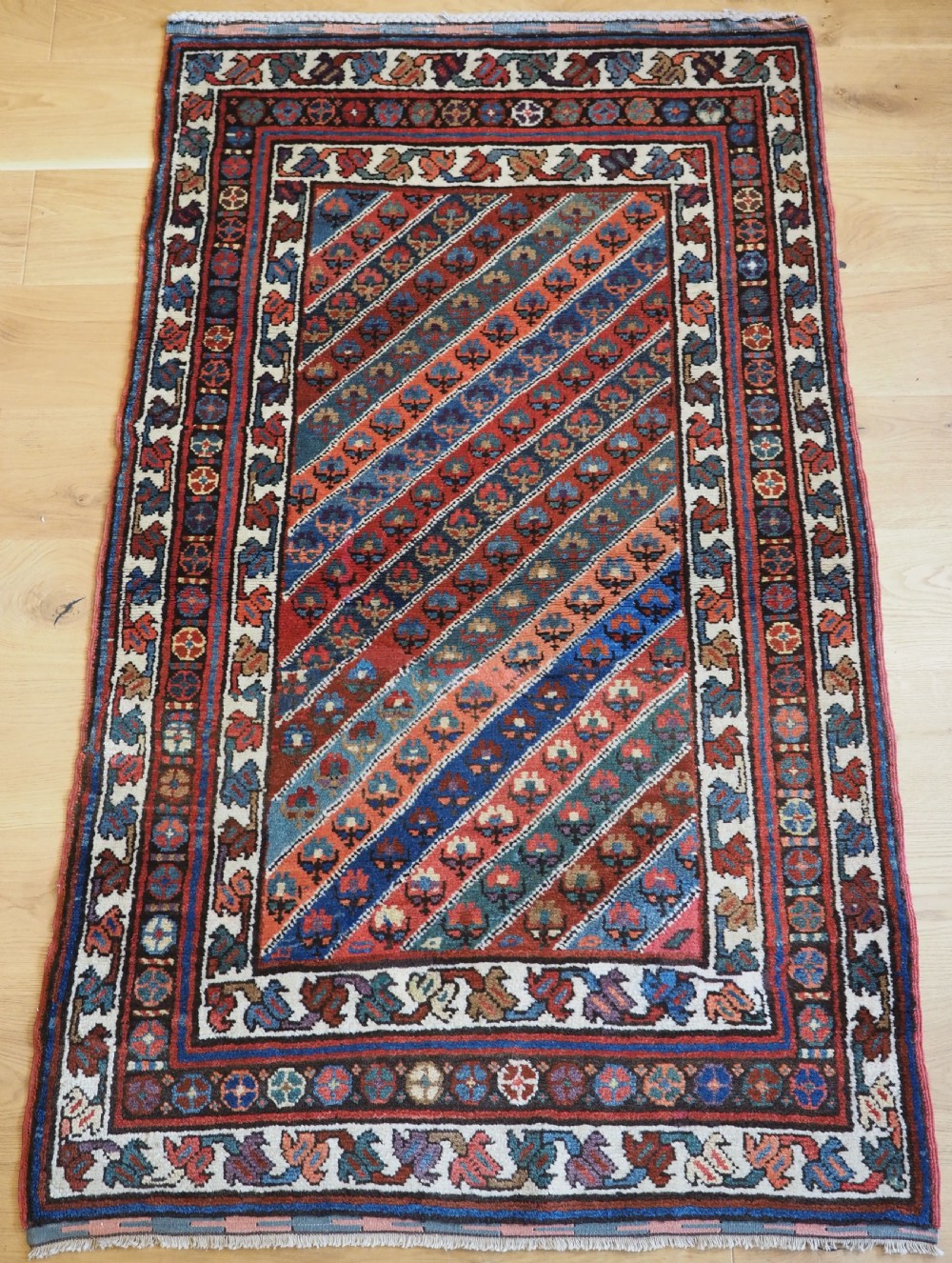 OLD KURDISH RUG WITH DIAGONAL STRIPE DESIGN, SOUTHERN CAUCAUS, CIRCA 1930.