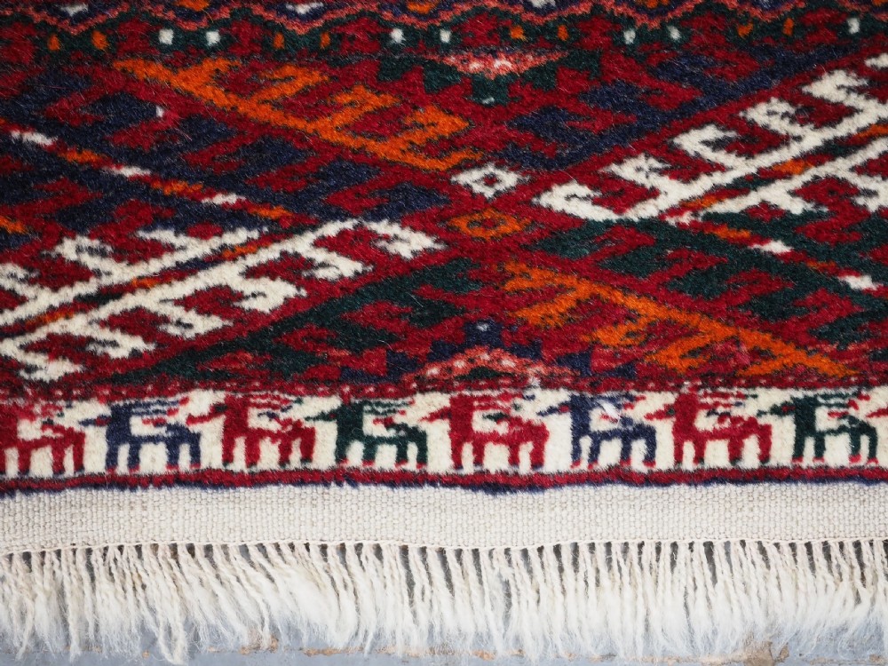 OLD TEKKE TURKMEN RUG, ROWS OF SMALL ANIMALS, CIRCA 1920/30. View X