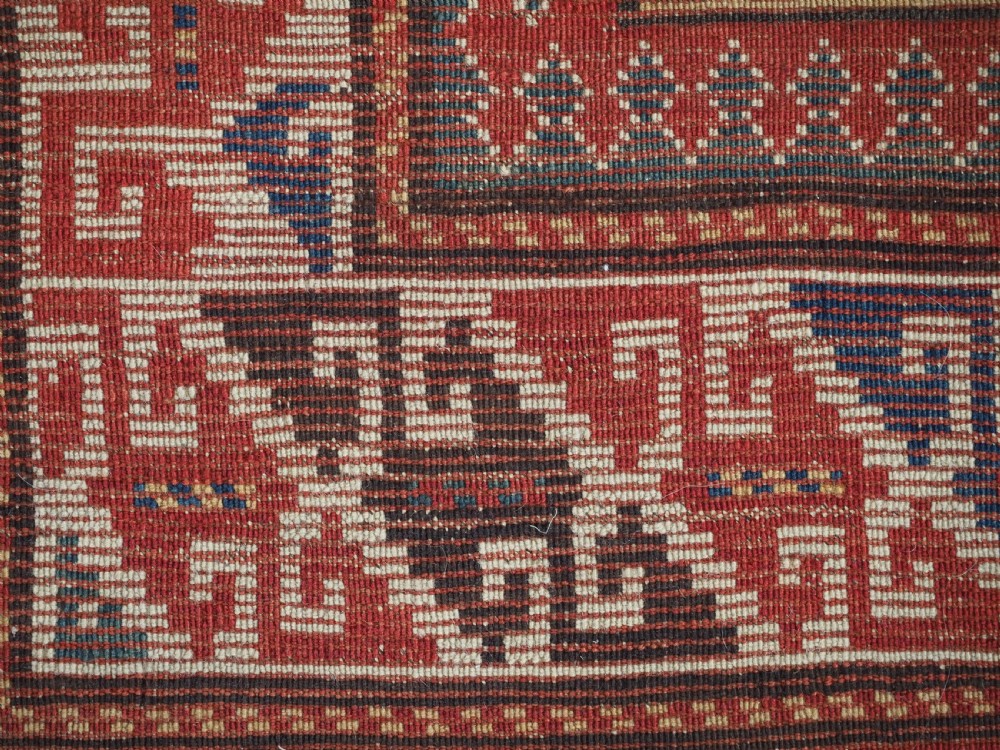 An antique Caucasian Bordjalou Kazak rug featuring a central navy blue field with two large red diamond medallions, zoomorphic animal motifs, and multi-layered geometric borders. View XVI