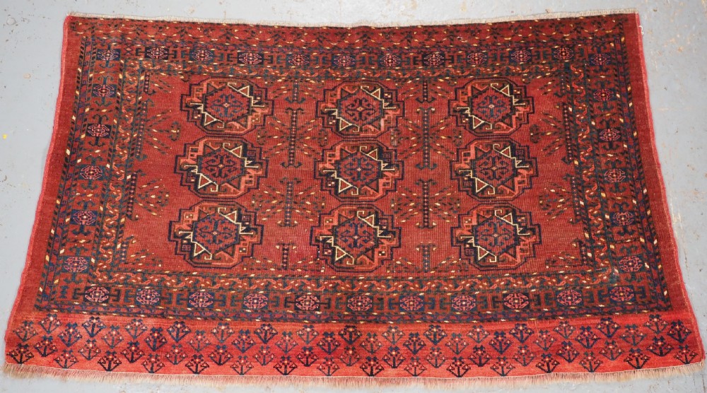 ANTIQUE ERSARI KIZIL AYAK TURKMEN NINE GUL CHUVAL, CIRCA 1900.