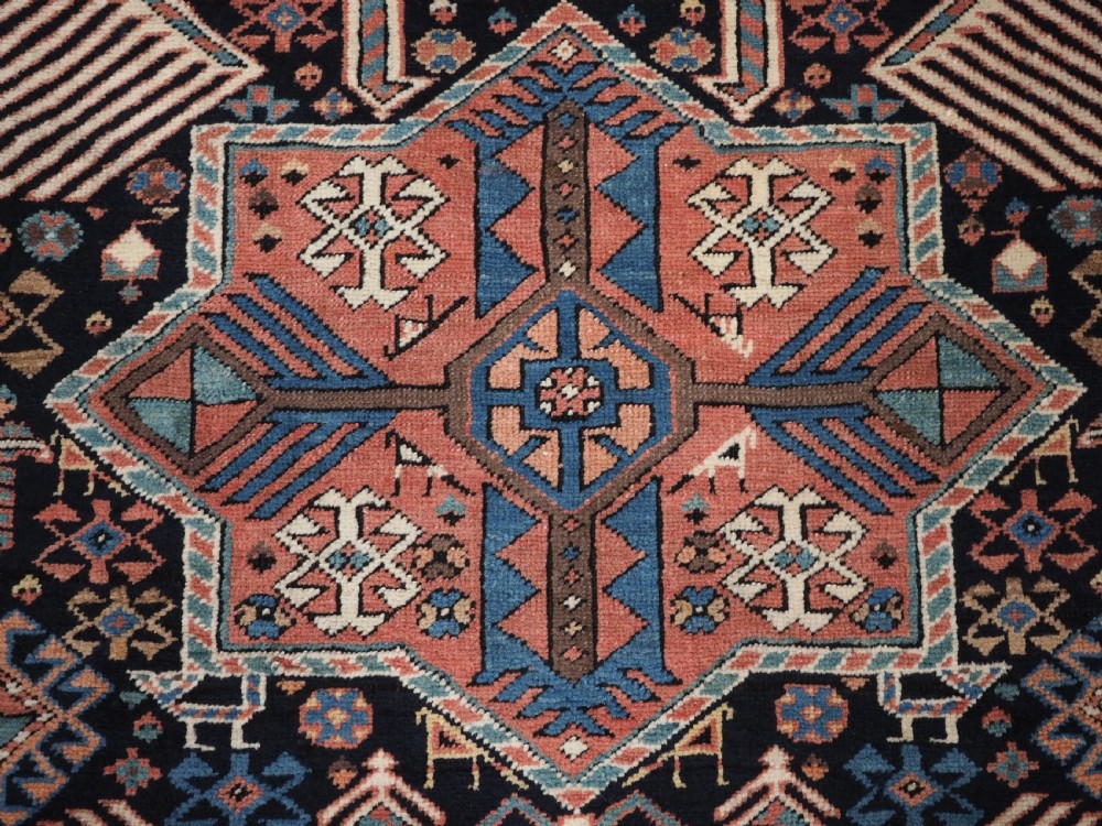 An antique Caucasian Akstafa wool rug runner featuring geometric star medallions and stylised peacock motifs on a dark navy field with a decorative border. View IX