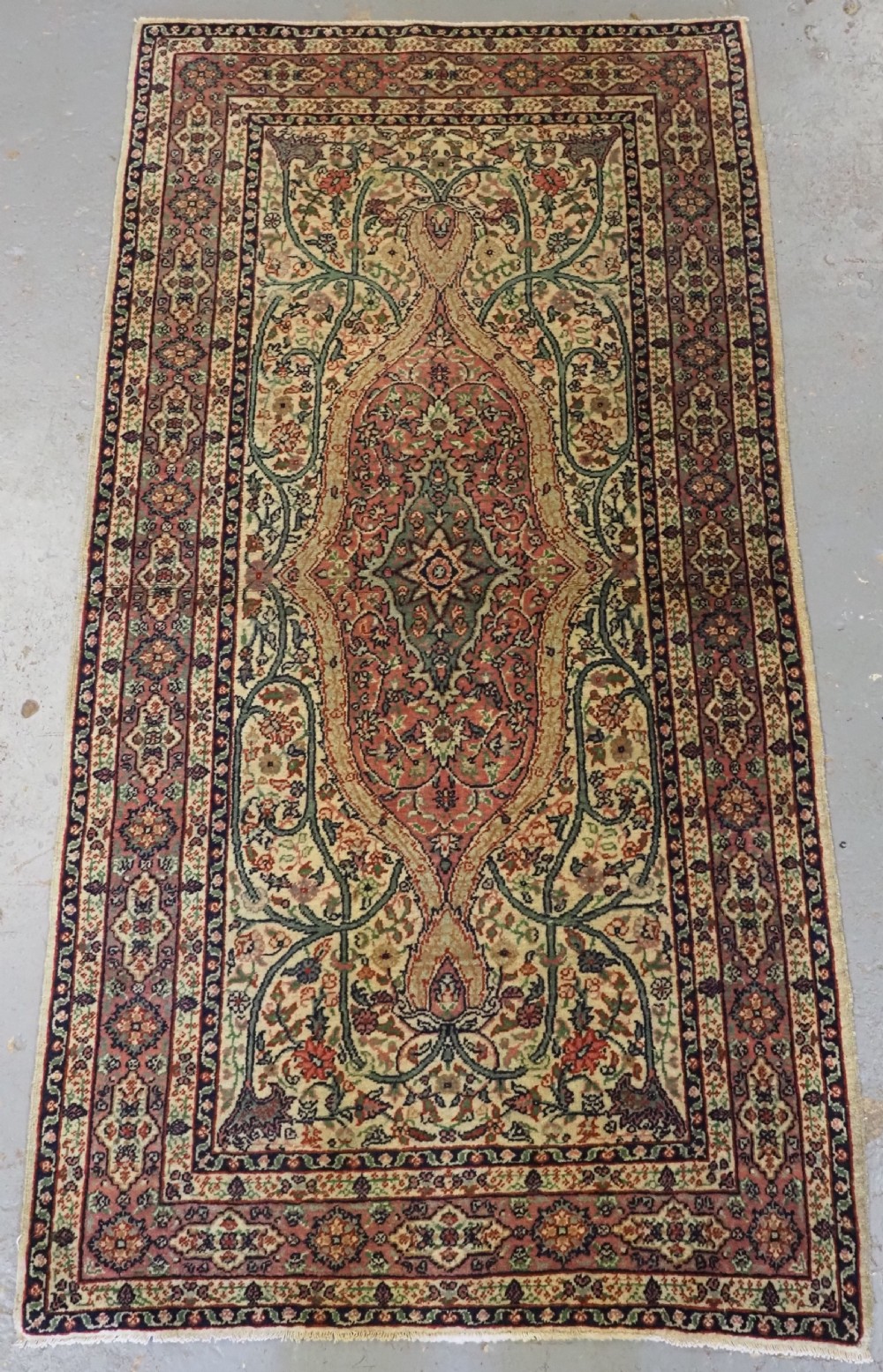 An antique hand-knotted Turkish Sivas wool rug featuring a central medallion surrounded by floral arabesque patterns in terracotta, cream, and muted green tones.