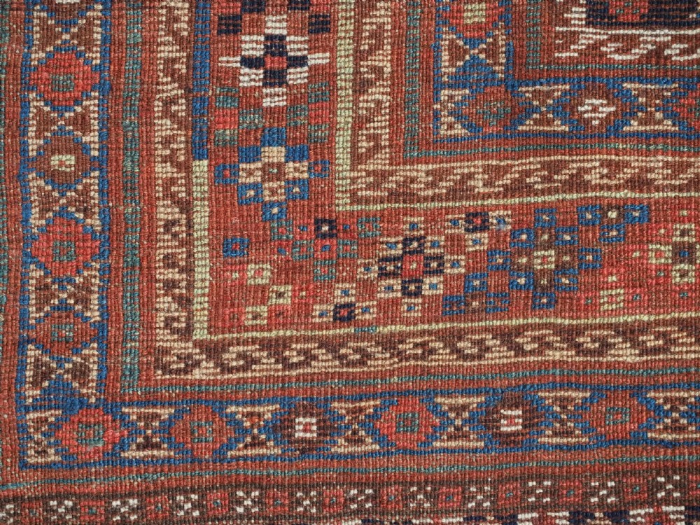 An antique Qashqai hand-knotted wool rug featuring a red and navy diamond lattice pattern with multi-band geometric borders. View XVIII