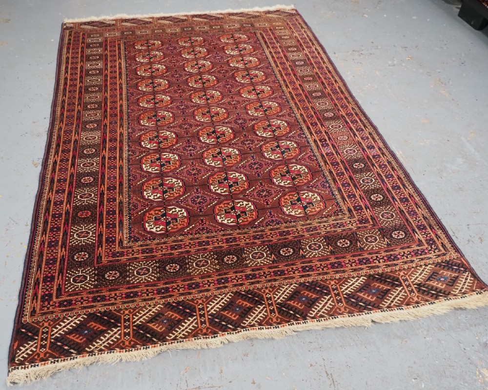ANTIQUE TEKKE TURKMEN RUG, COCHINEAL DYE HIGHLIGHTS, CIRCA 1900. View II