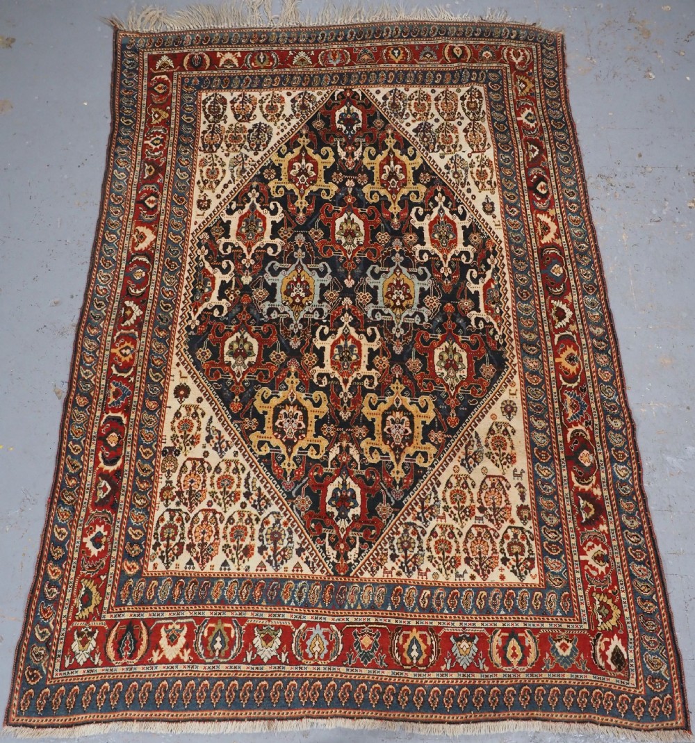 ANTIQUE QASHQAI KASHKULI RUG WITH REPEAT MEDALLION DESIGN, CIRCA 1900.