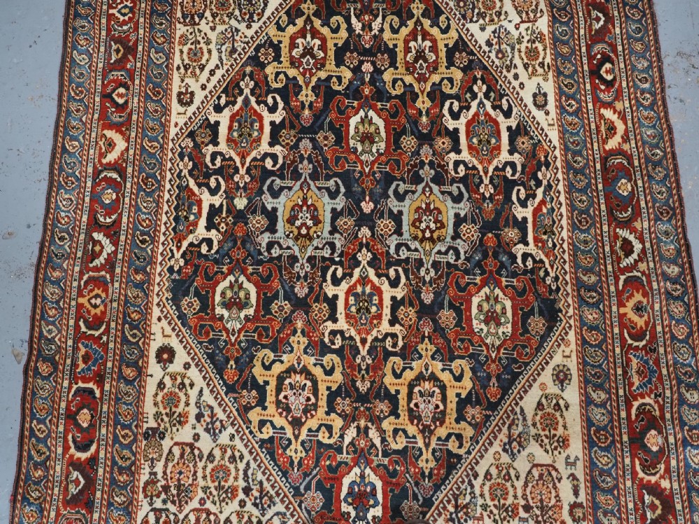 ANTIQUE QASHQAI KASHKULI RUG WITH REPEAT MEDALLION DESIGN, CIRCA 1900. View IV