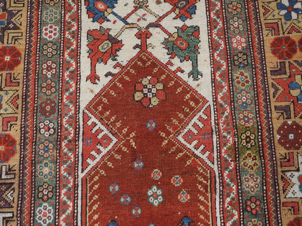 ANTIQUE TURKISH MILAS PRAYER RUG, STAR & ROSETTE BORDER, CIRCA 1800-1825. View IX