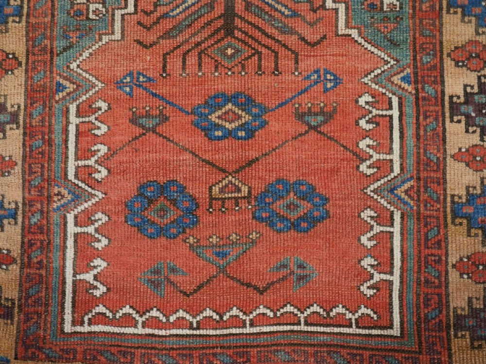 An antique hand-knotted Turkish Konya prayer rug featuring a stepped central red niche surrounded by green, blue, and ochre geometric motifs. View VIII