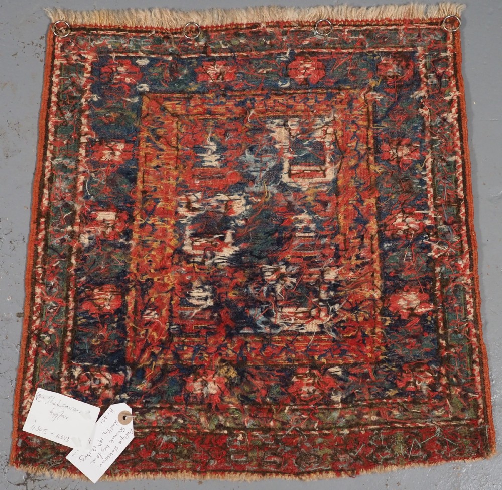 A square antique woven wool Shahsavan Soumak textile panel displaying geometric dragon and bird motifs on a dark navy background framed by red floral borders. View VIII
