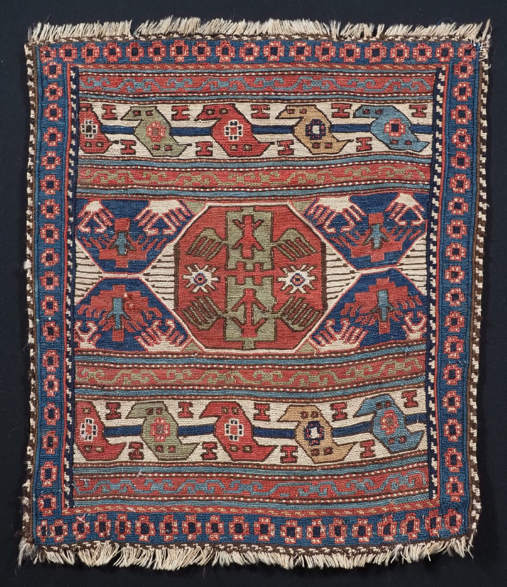A square antique Shahsevan Soumak woven wool panel featuring central geometric octagonal medallions flanked by bird and dragon motifs in shades of terracotta red, blue, and ivory.