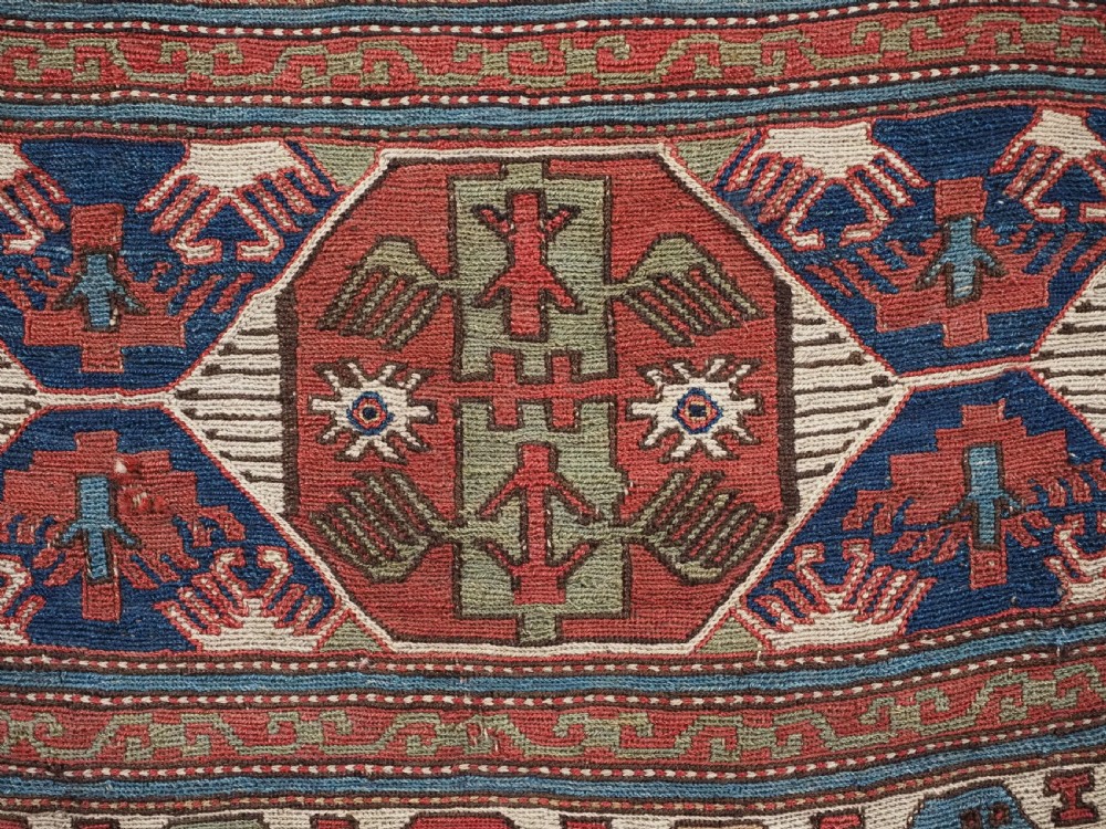 A square antique Shahsevan Soumak woven wool panel featuring central geometric octagonal medallions flanked by bird and dragon motifs in shades of terracotta red, blue, and ivory. View VI