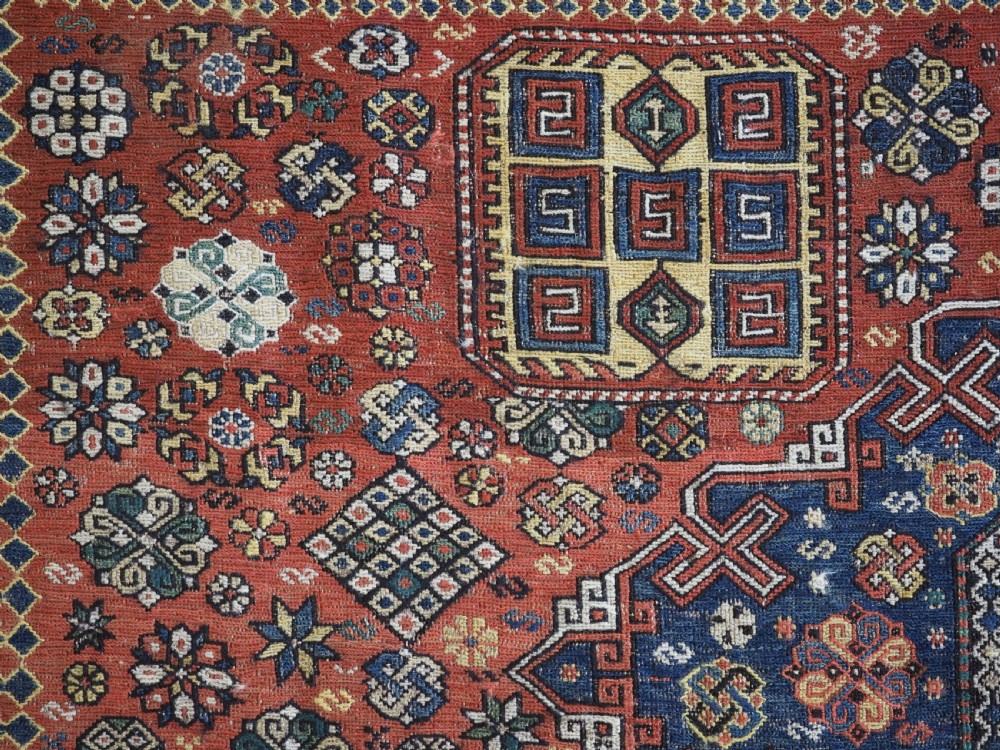 An antique Caucasian flatweave Soumak rug featuring three large geometric medallions on a red field framed by a patterned yellow border. View VIII