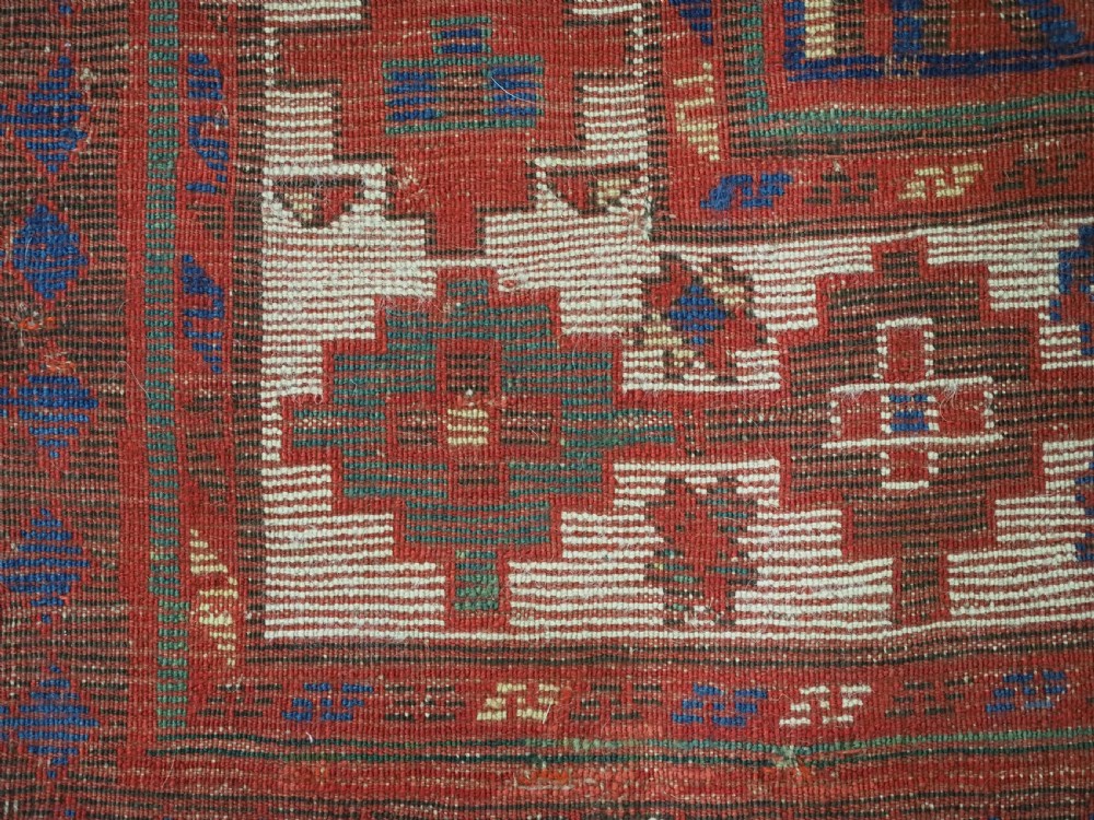 An antique Caucasian Moghan Kazak wool runner rug with repeating diamond hooked medallions on a deep blue field and geometric borders. View XIII