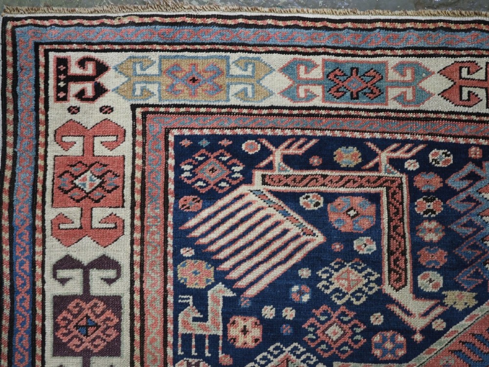 An antique Caucasian Akstafa long rug runner featuring three star medallions and stylized peacock motifs on a dark navy blue field with geometric borders. View VII