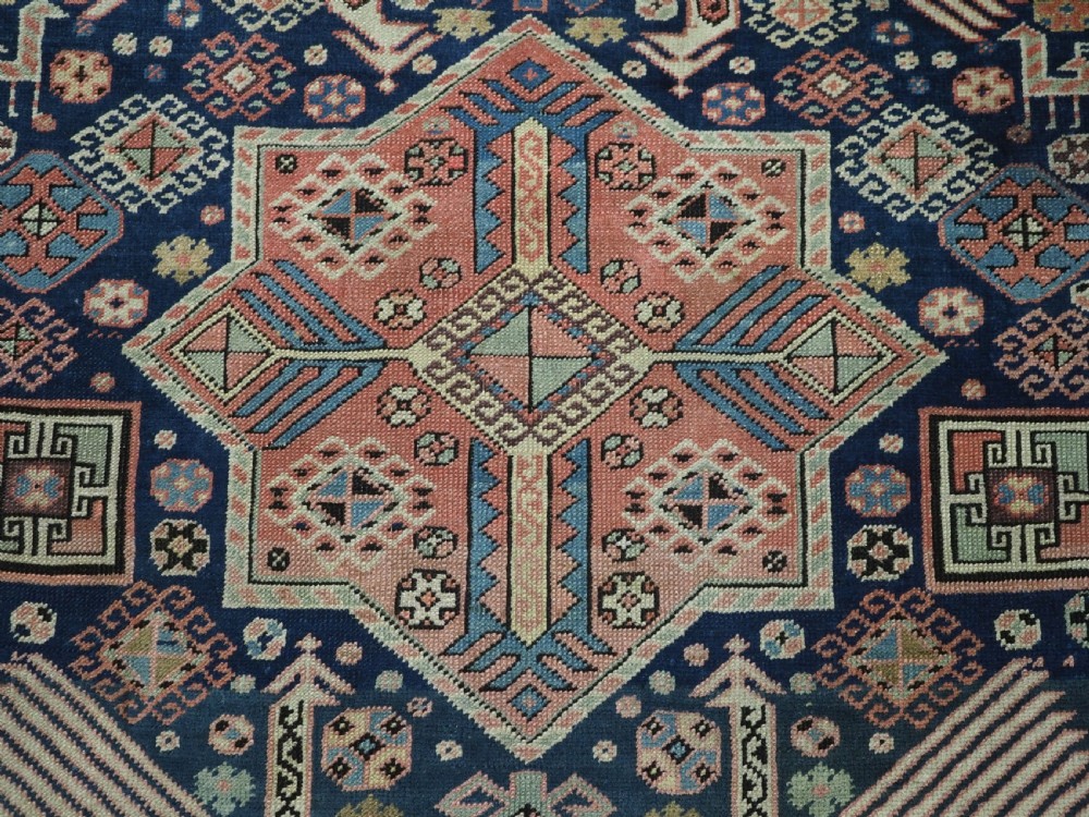 An antique Caucasian Akstafa long rug runner featuring three star medallions and stylized peacock motifs on a dark navy blue field with geometric borders. View XIV