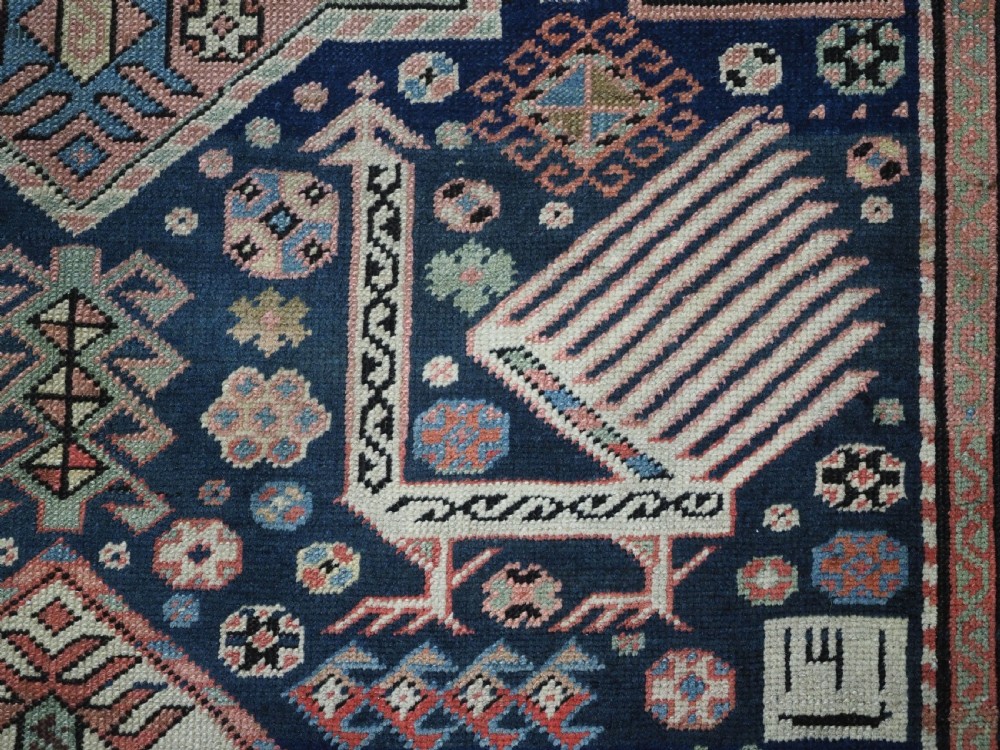An antique Caucasian Akstafa long rug runner featuring three star medallions and stylized peacock motifs on a dark navy blue field with geometric borders. View XV
