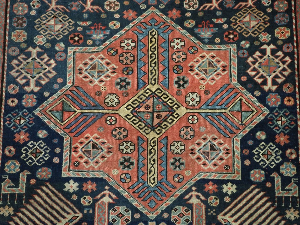 An antique Caucasian Akstafa long rug runner featuring three star medallions and stylized peacock motifs on a dark navy blue field with geometric borders. View XVIII